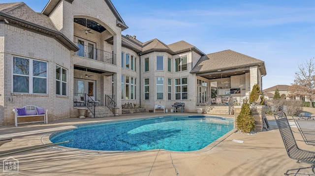 pool with a patio area and ceiling fan