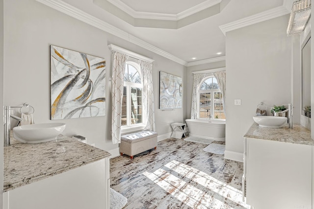 full bath with two vanities, a sink, and crown molding