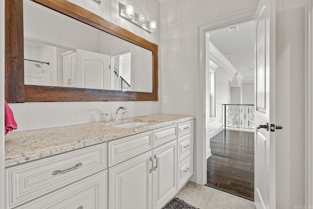 bathroom featuring ornamental molding, visible vents, vanity, and wood finished floors