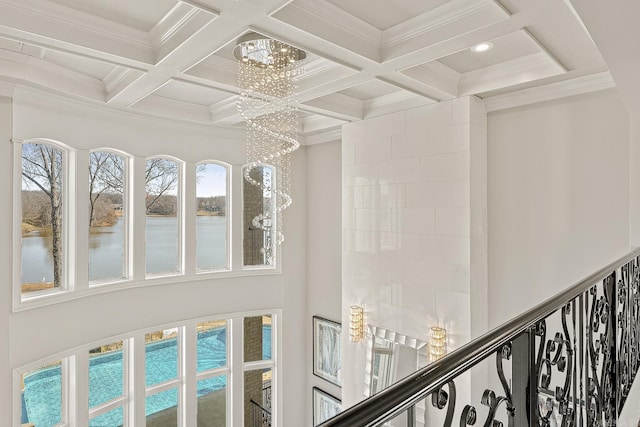 room details featuring a chandelier, coffered ceiling, beamed ceiling, and ornamental molding