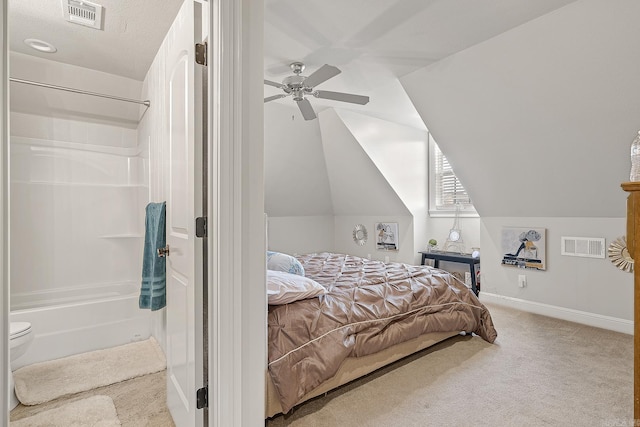 bedroom with vaulted ceiling, carpet flooring, visible vents, and baseboards