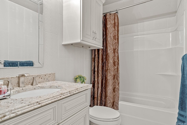 full bathroom featuring toilet, shower / bath combination with curtain, and vanity