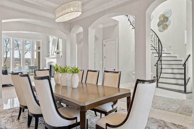 dining space featuring light tile patterned floors, baseboards, stairway, and crown molding