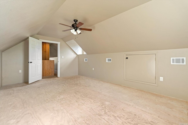 additional living space featuring a ceiling fan, visible vents, and vaulted ceiling