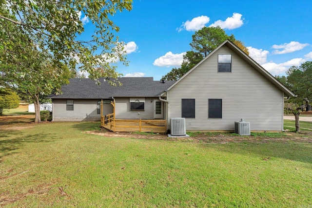 rear view of property with central AC, a yard, and a wooden deck