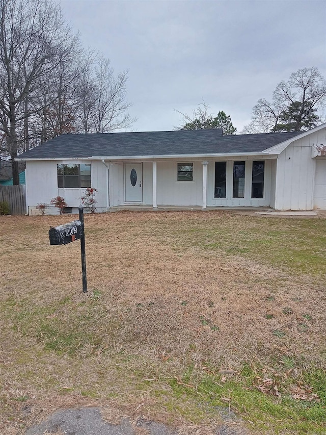 ranch-style house featuring a front yard and roof with shingles