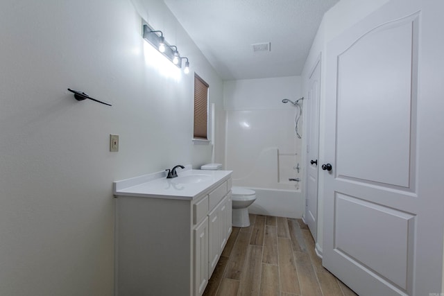 bathroom with visible vents, toilet, wood finished floors, tub / shower combination, and vanity