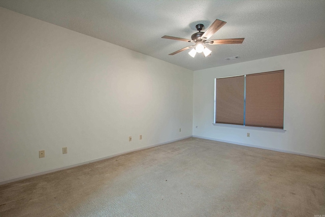 empty room featuring baseboards, ceiling fan, visible vents, and carpet flooring