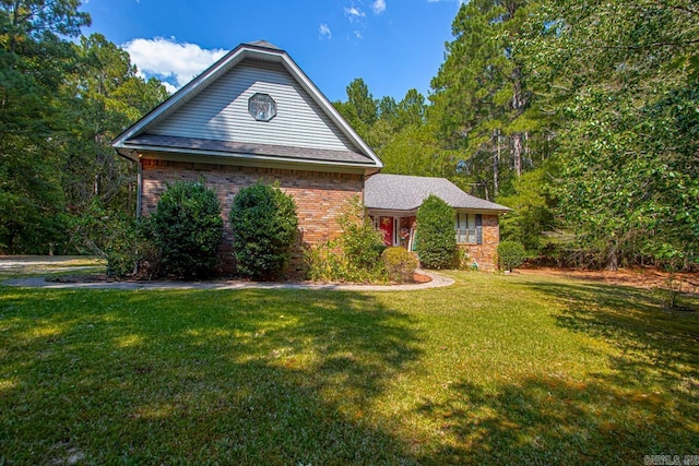 view of front of house featuring brick siding and a front lawn