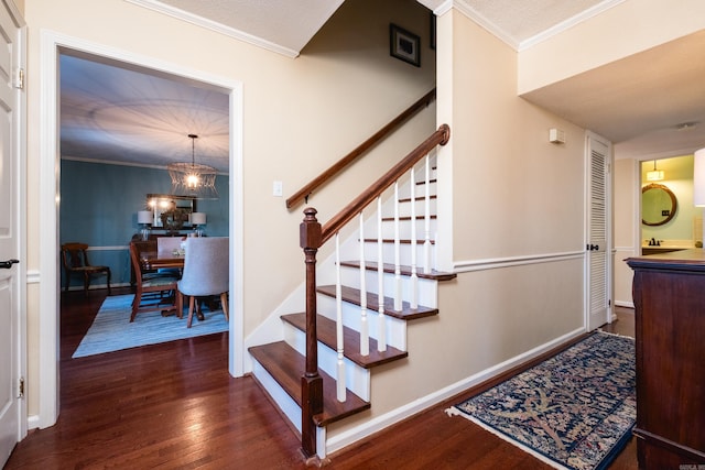 staircase featuring ornamental molding, baseboards, and wood finished floors