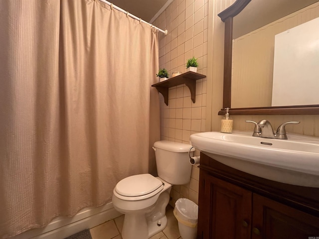 bathroom featuring toilet, vanity, tile walls, and tile patterned floors