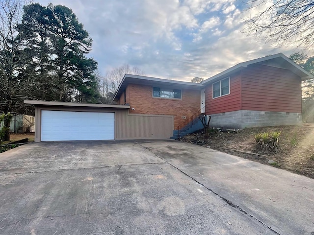 view of property exterior with crawl space, driveway, and a garage