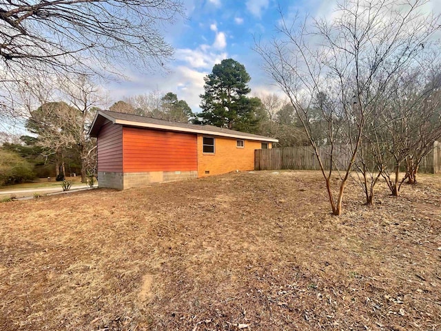 view of property exterior with crawl space and fence