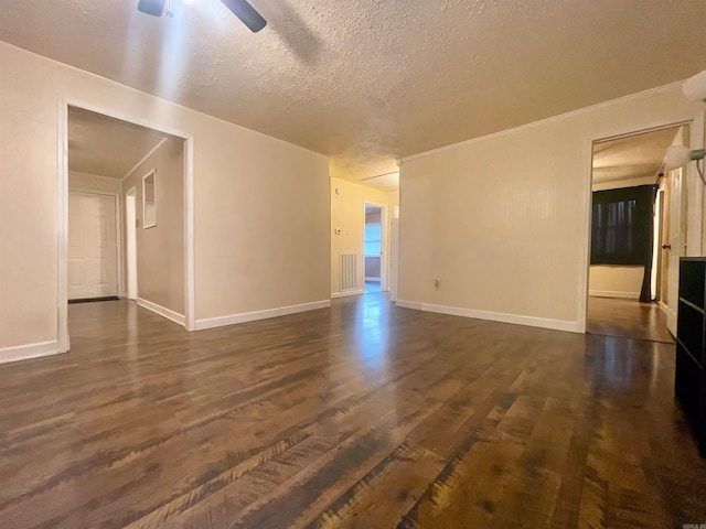 unfurnished living room with dark wood-style floors, ceiling fan, a textured ceiling, and baseboards