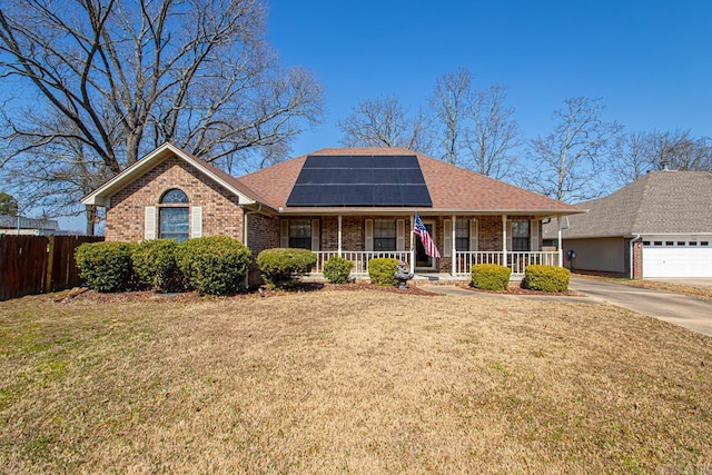 ranch-style home with a front yard, covered porch, brick siding, and roof mounted solar panels