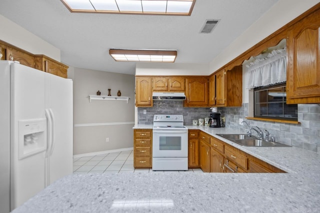 kitchen with visible vents, white appliances, light countertops, and under cabinet range hood