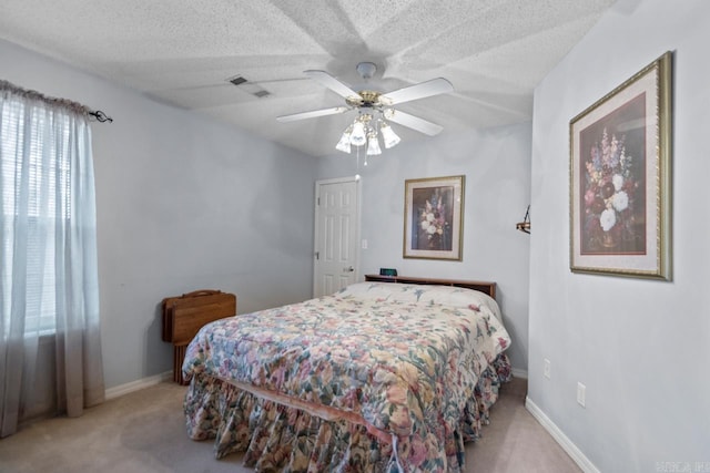 bedroom featuring carpet floors, visible vents, a textured ceiling, and baseboards