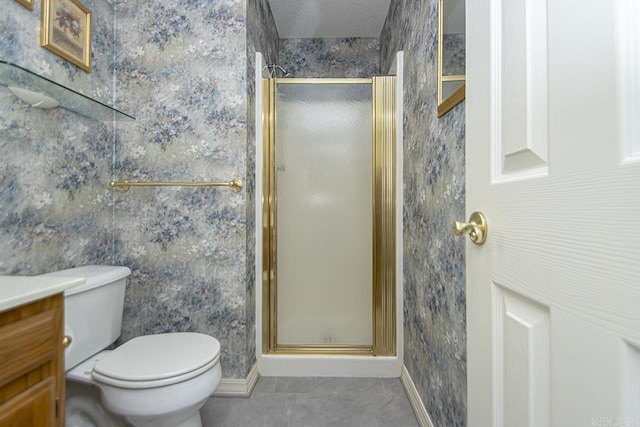 full bath with toilet, vanity, baseboards, a shower stall, and tile patterned floors