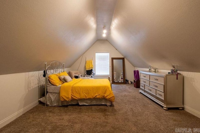 carpeted bedroom with vaulted ceiling, a textured ceiling, and baseboards