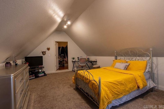 carpeted bedroom featuring vaulted ceiling and a textured ceiling