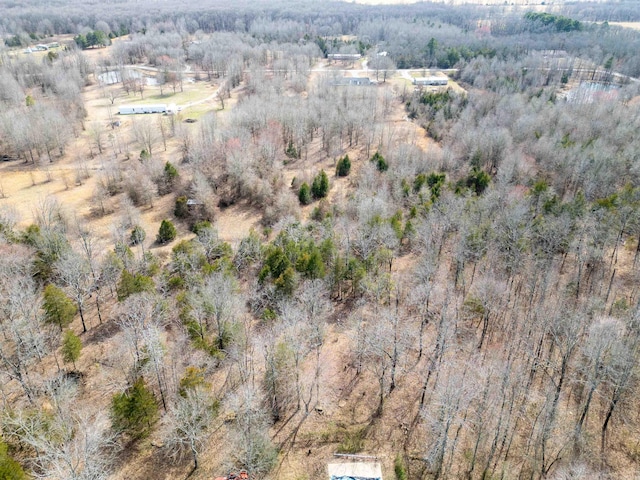 birds eye view of property with a view of trees