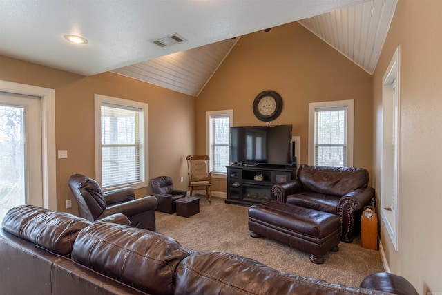 living area featuring carpet floors, baseboards, visible vents, and lofted ceiling