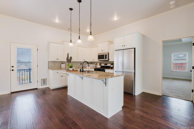 kitchen featuring appliances with stainless steel finishes, tasteful backsplash, light stone countertops, and dark wood-style floors