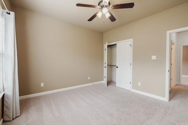 unfurnished bedroom with a ceiling fan, a closet, light colored carpet, and baseboards