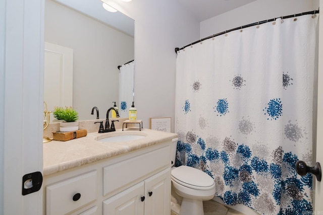 full bath featuring vanity and toilet