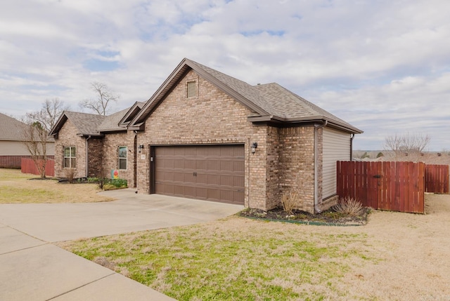 view of front of home featuring concrete driveway, brick siding, an attached garage, and fence