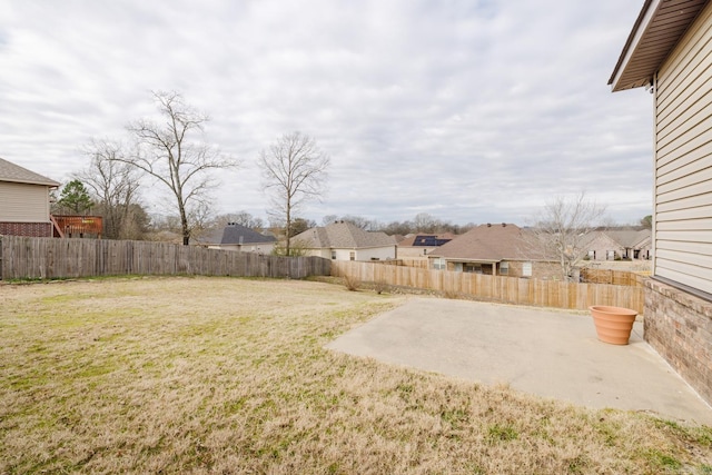 view of yard with a fenced backyard, a residential view, and a patio