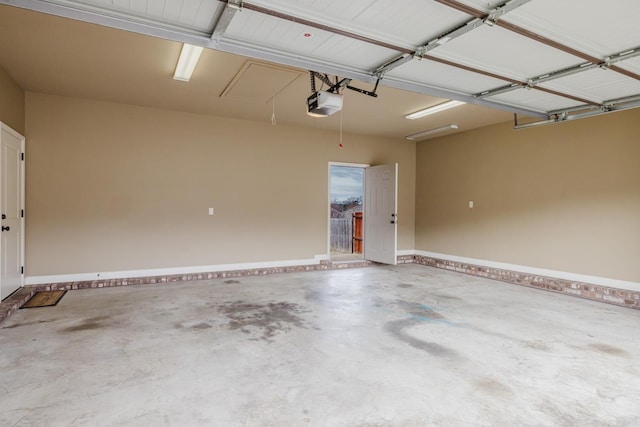 garage with baseboards and a garage door opener