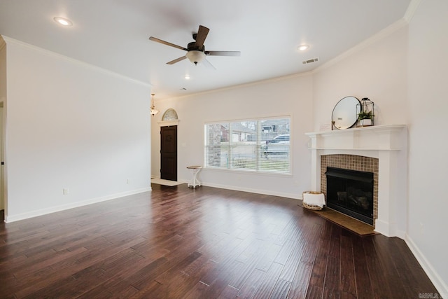 unfurnished living room featuring ornamental molding, a tile fireplace, wood finished floors, and visible vents