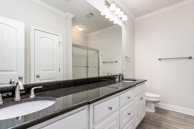 bathroom featuring ornamental molding, visible vents, a sink, and double vanity