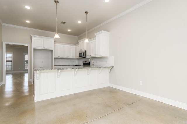 kitchen with decorative backsplash, appliances with stainless steel finishes, light stone countertops, a peninsula, and baseboards