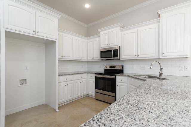 kitchen with backsplash, appliances with stainless steel finishes, light stone counters, and a sink