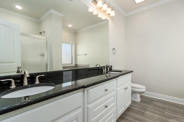 full bath featuring ornamental molding, a stall shower, a sink, and baseboards