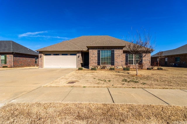 ranch-style house featuring a garage, concrete driveway, brick siding, and a shingled roof