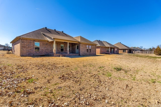 back of property featuring brick siding