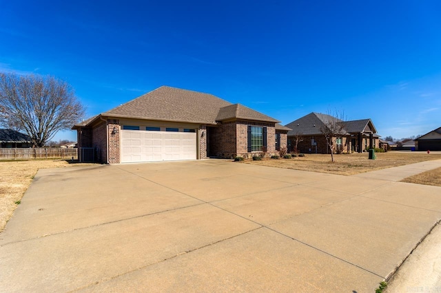 view of front facade featuring concrete driveway, an attached garage, fence, cooling unit, and brick siding