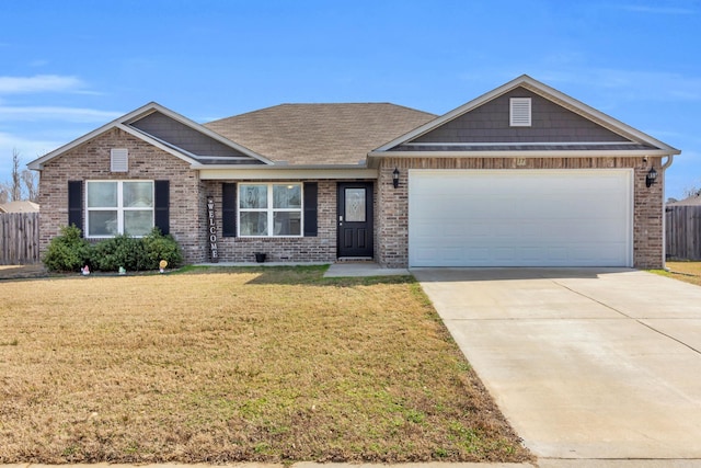 view of front facade with a front yard, fence, concrete driveway, and brick siding