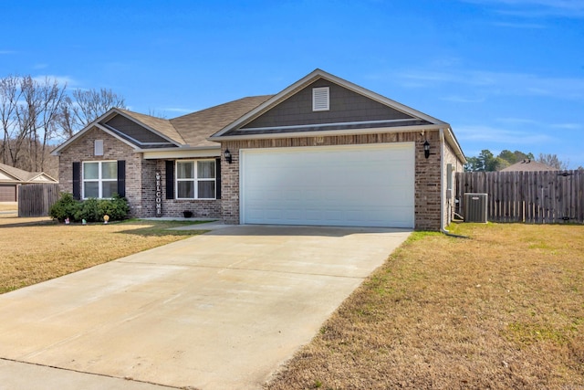 view of front of home with an attached garage, brick siding, fence, and a front lawn