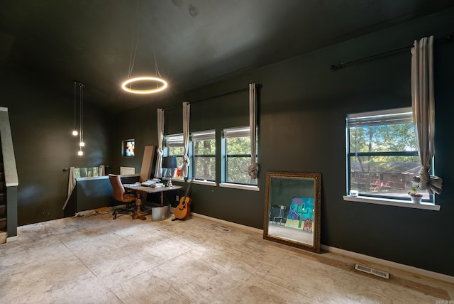 office area with visible vents, plenty of natural light, and baseboards