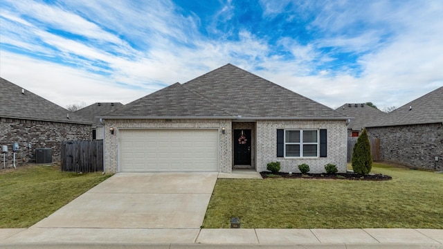 view of front of property featuring a garage, a front lawn, brick siding, and central air condition unit