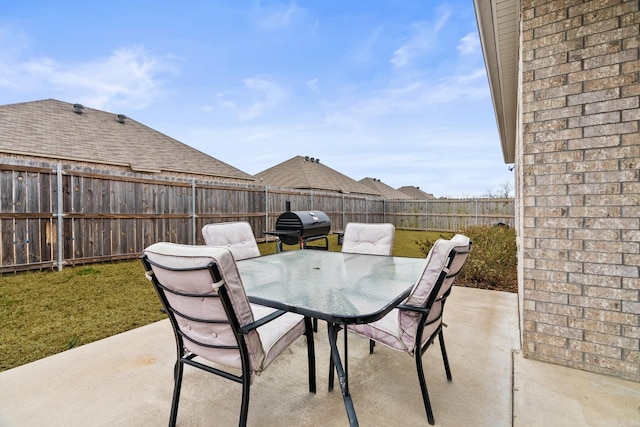 view of patio with a fenced backyard and outdoor dining area