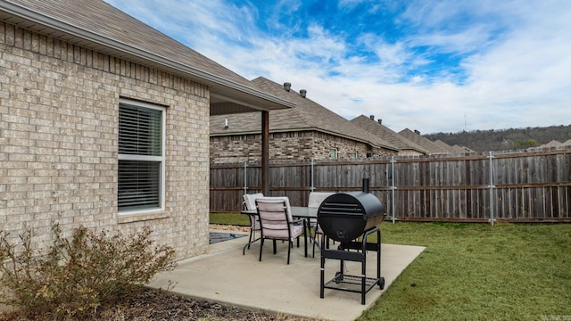 view of patio / terrace with fence and a grill