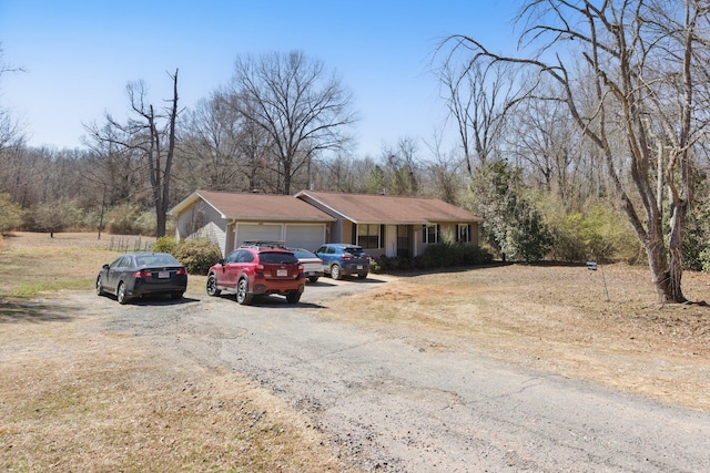 single story home with driveway and an attached garage