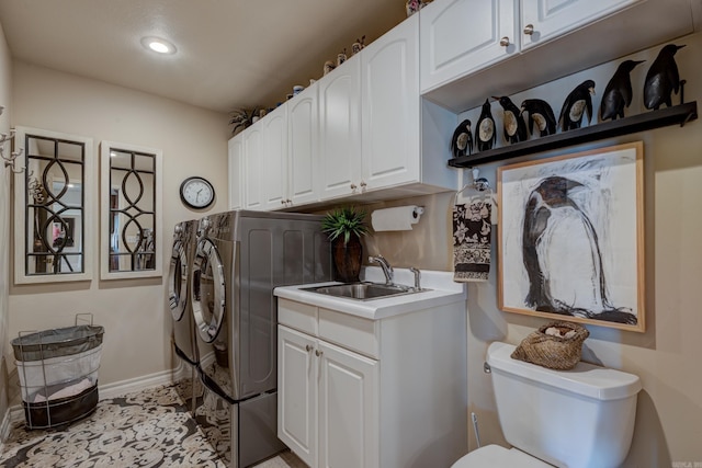 clothes washing area with a sink, recessed lighting, washing machine and dryer, and baseboards