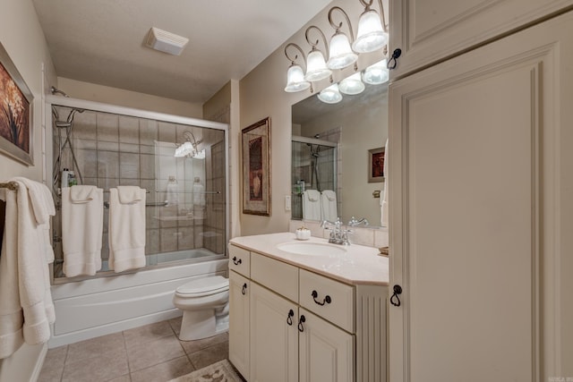 bathroom featuring combined bath / shower with glass door, vanity, toilet, and tile patterned floors