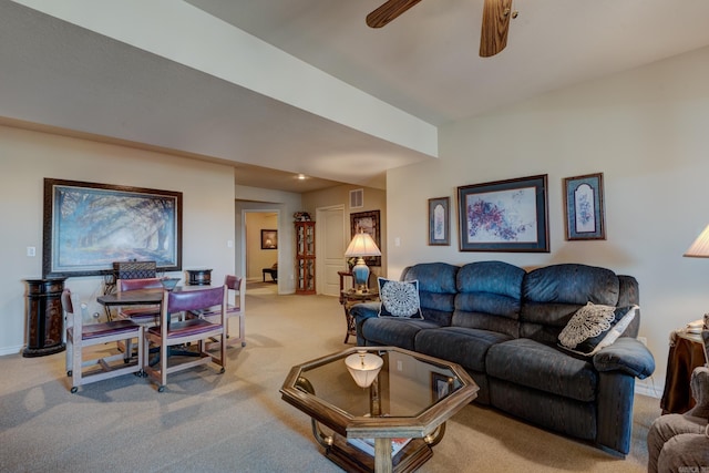 living area featuring light carpet, baseboards, visible vents, and a ceiling fan